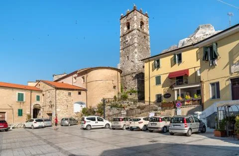Central square with bell tower in ancient village Colonnata in Tuscany, Italy Stock Photos