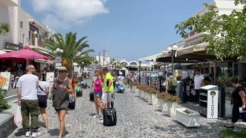 Central square full of tourists with baggages in Thira, Santorini, Greece Stock Footage 150728405