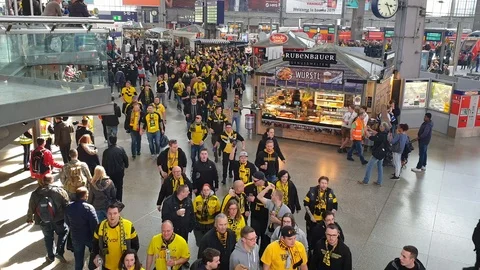 CENTRAL STATIONS, MUNICH, APRIL 6, 2019: bvb fans on the way to the soccer game Stock-Footage 105926368