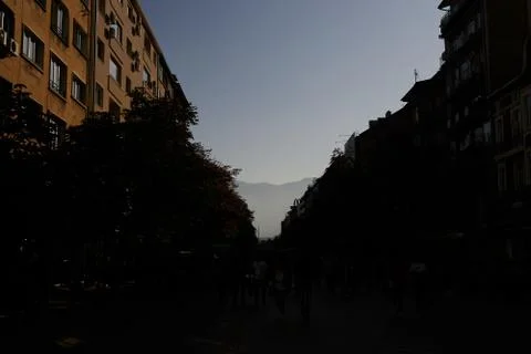 Central street in Sofia, Bulgaria in shadow and mountains Stock-Fotos