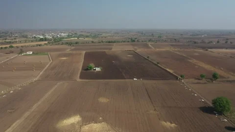 Central wide angle drone view focusing on a small farming hut and a white Stock Footage 337547723