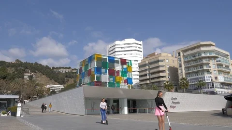 Centre Pompidou in Malaga and electric scooters crossing scene. Stock Footage 103838053