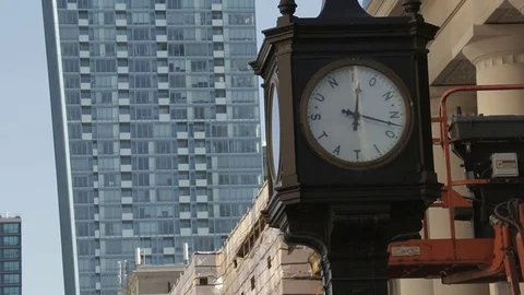 Century old clock train station clock with tilt to modern day skyscraper Stock Footage 73966147