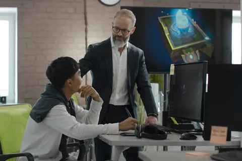 CEO of company studio developers of games discusses with the artist 3D model Stock Photos