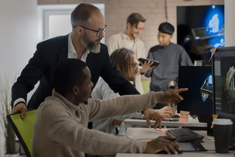 CEO of company studio developers of games discusses with the artist 3D model Stock Photos