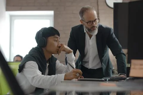 CEO of company studio developers of games discusses with the artist 3D model Stock Photos