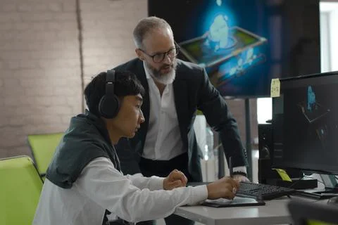 CEO of company studio developers of games discusses with the artist 3D model Stock Photos