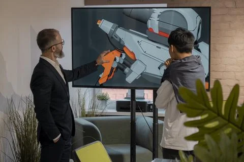 CEO of company studio developers of games discusses with the artist 3D model Stock Photos
