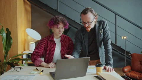 CEO Explaining Business Plan on Laptop to Female Employee with Prosthetic Arm Stock Footage 281193722