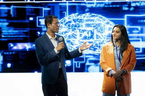 CEO presents artificial intelligence tech prototype on stage, speaking in mic Stock Photos