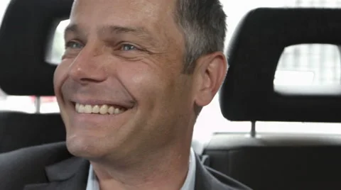 CEO smiling and laughing in back of taxi Stock Footage 41265690