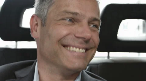 CEO smiling and laughing in back of taxi Stock Footage 41266971