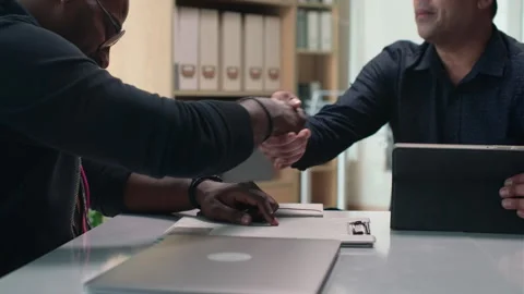 CEO Welcoming New Coder to Team while Sitting Together at Table Stock Footage 252569240