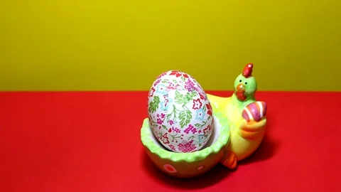 Ceramic and colorful easter chicken holding easter egg 動画素材 86798519