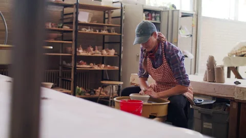 A ceramic artist working in a pottery studio Stock Footage 138595949