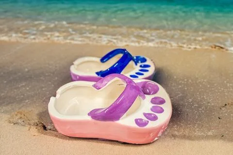 Ceramic ashtray in the shape of a flip flop by the sea. Tourism.Vacation Concept Stock Photos
