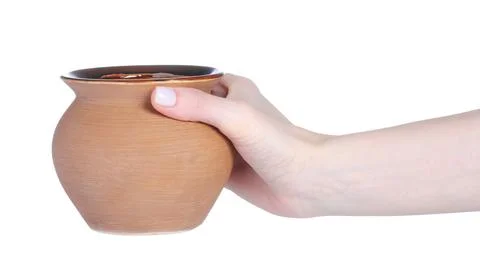 Ceramic baking pot in hand Stock Photos