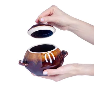 Ceramic baking pot in hand Stock Photos