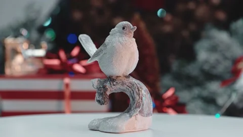 Ceramic beautiful bird on the background of a snow-covered forest. Stock Footage 145372017
