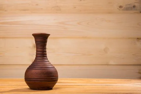 Ceramic bottle on wooden background. Stock Photos