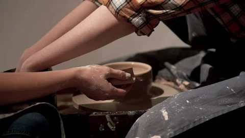 Ceramic bowl making by artist with help of teacher. Pottery workshop Stock Footage 201568548