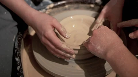 Ceramic bowl making by young lady hands with help of teacher Stock Footage 201568453
