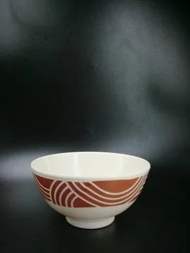 Ceramic bowl with noodle pattern, brown at the top, plain white at the bottom Stock Photos
