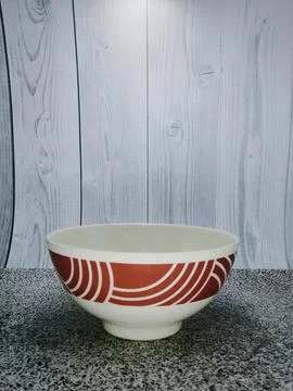 Ceramic bowl with noodle pattern, brown at the top, plain white at the bottom Stock Photos