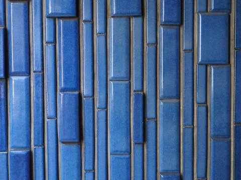 Ceramic brick pattern background photograph, vertical blue glazed bricks. Stock Photos