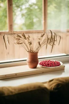 Ceramic brown jug with a bunch of ears of corn. Picture of a rural life. Stock Photos