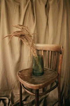 Ceramic brown jug with a bunch of ears of corn. Picture of a rural life. Stock Photos