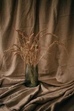 Ceramic brown jug with a bunch of ears of corn. Picture of a rural life. Stock Photos