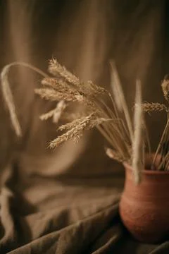 Ceramic brown jug with a bunch of ears of corn. Picture of a rural life. Stock Photos