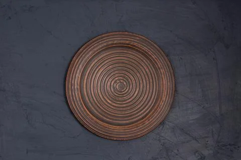 Ceramic brown plate on a black background Stock Photos