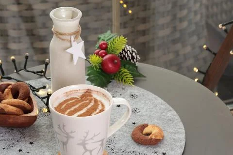 Ceramic cappuccino cup and table decor. Christmas festivities. Background for Stock Photos