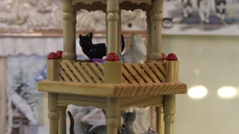 Ceramic cat figurines on a rotating stand in the museum Stock Footage 297461641