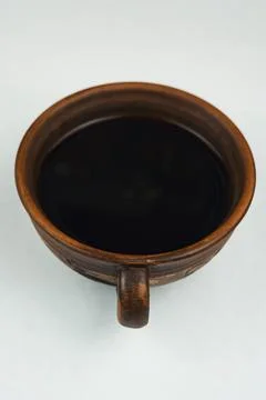 Ceramic coffee cup filled with black coffee on light background Foto stock
