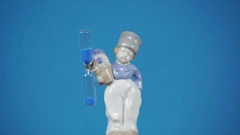 Ceramic Composition Boy with Hourglass. Stock Footage 302586861