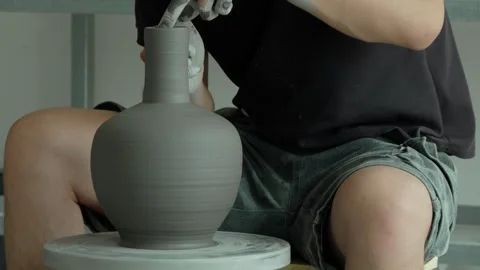 Ceramic Craftsman Checking Dried Clay Vase on Spinning Wheel Stock Footage 338187723