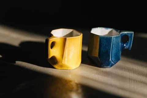 Ceramic cup for coffee on the table. Blue and yellow 스톡 사진