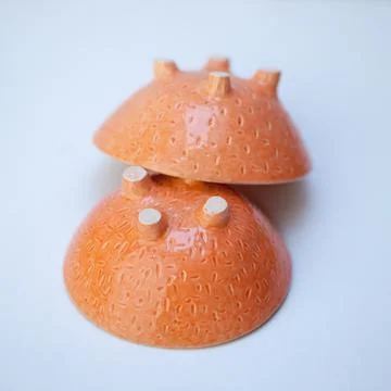 Ceramic cup in the form of half a grapefruit. Stock Photos