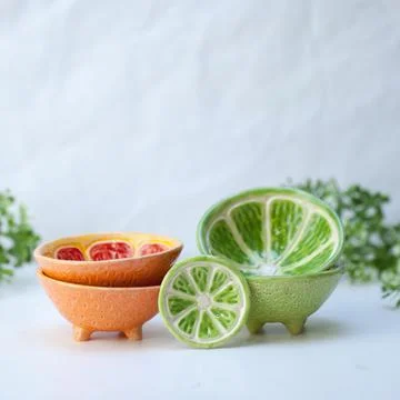 Ceramic cup in the form of half a lime. Stock Photos