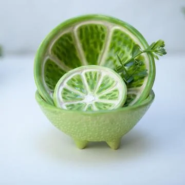 Ceramic cup in the form of half a lime. Stock Photos