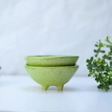 Ceramic cup in the form of half a lime. Stock Photos