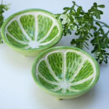 Ceramic cup in the form of half a lime. Stock Photos