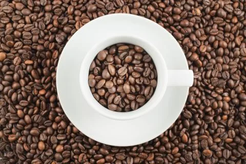 Ceramic cup full of coffee beans Stock Photos
