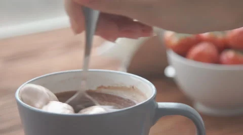 Ceramic cup of hot brown cacao stands on wooden table Stock Footage 68954677