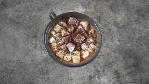 Ceramic cup of hot chocolate with marshmallow on gray table, Stock Footage 84455881