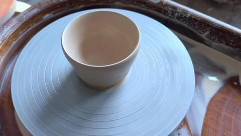 Ceramic cup on on pottery wheel, Close up, top view. Видео 292762612