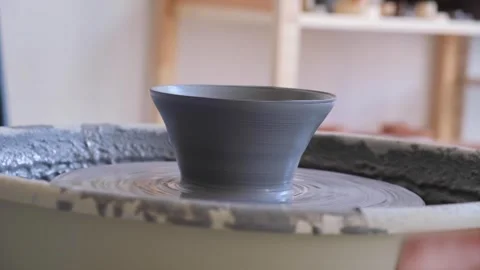 Ceramic cup on pottery wheel. Gray clay in workshop for creating a mug. Concept Stock Footage 279647199